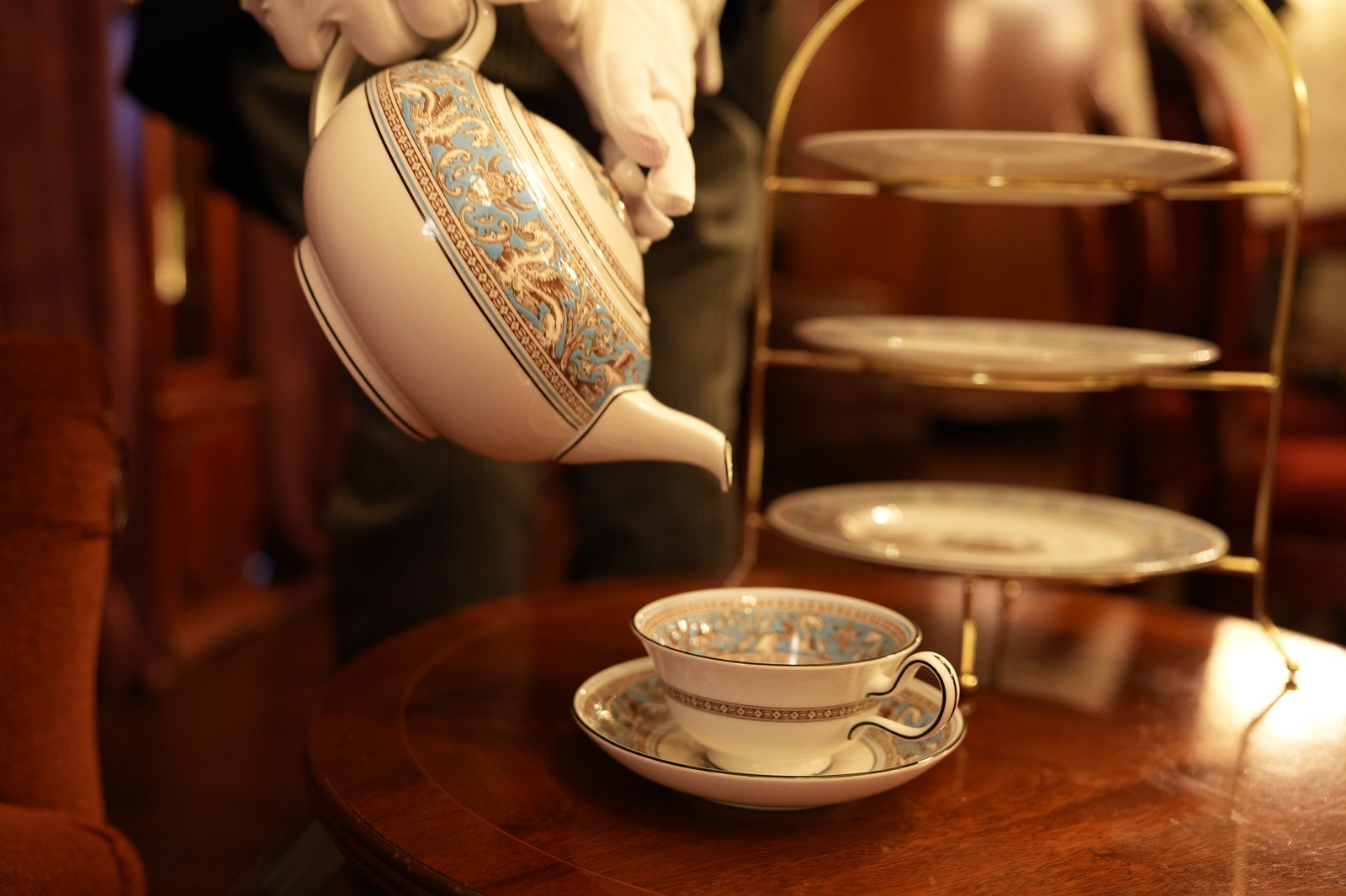 Tea being poured beside a three-tier stand (photograph from the Butler Bell site)