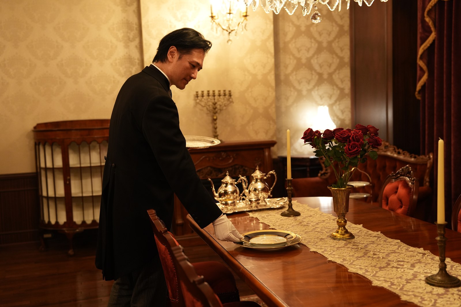 Butler Bell setting a plate on the table (photograph from the Butler Bell site)
