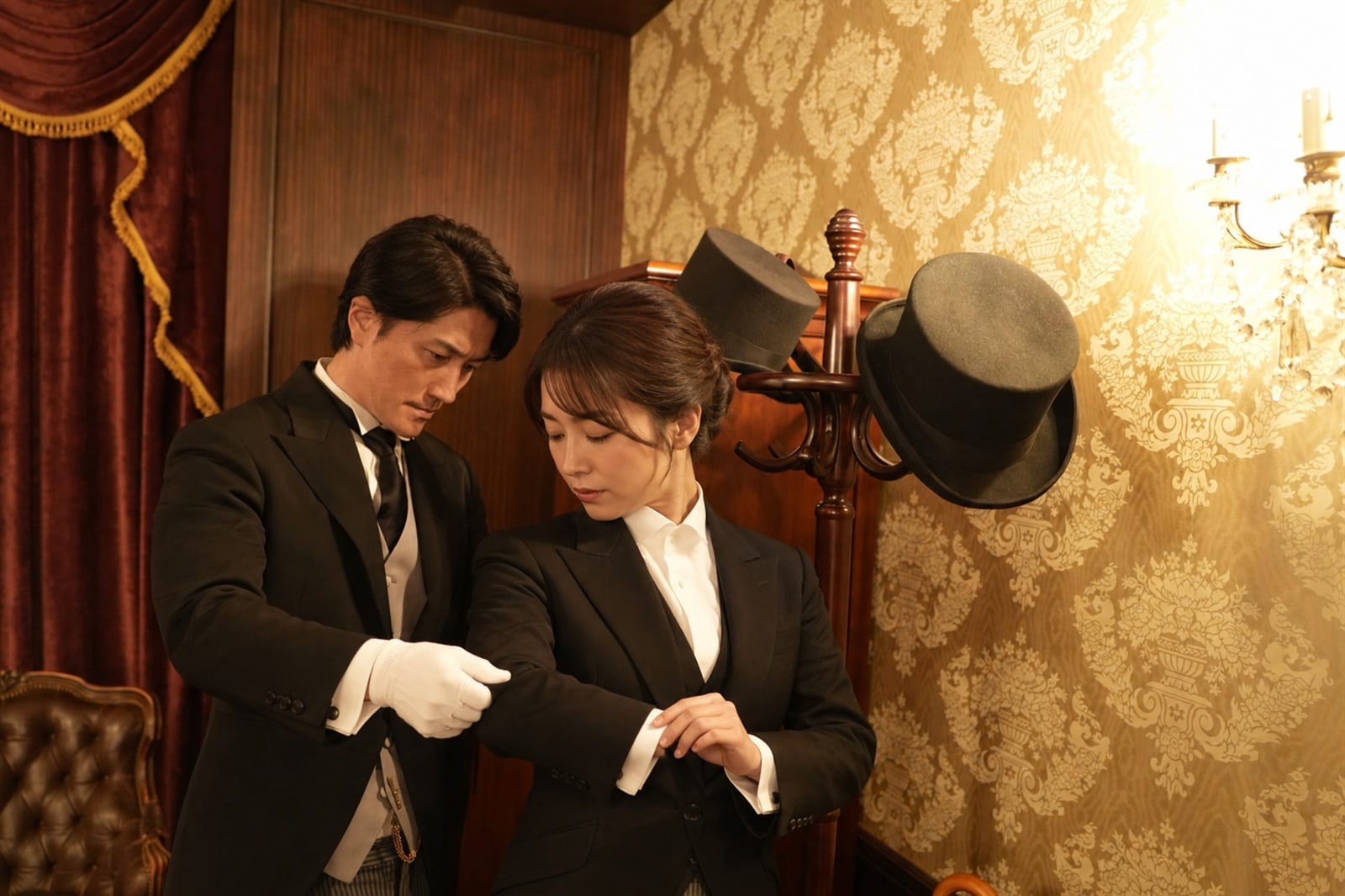 Adjusting attire in the wardrobe (Queen\'s Butler photograph)